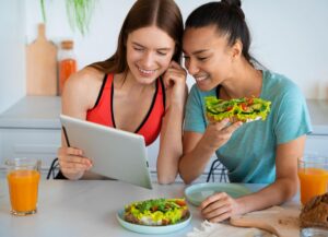 a woman sharing keto recipes to her friend: keto dining out adventures