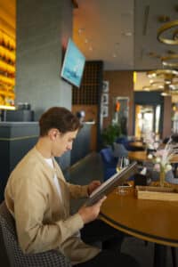 a man is deciphering restaurant menus