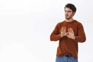 a man declining to eat unhealthy foods in a social gathering: keto dining out etiquette