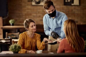 a woman ordering a food for their keto dining out