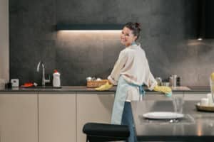 Housework. A woman looking busy while doing a kitchen clean out