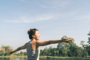 A picture of a woman breathing a fresh air and draws a smile on her face