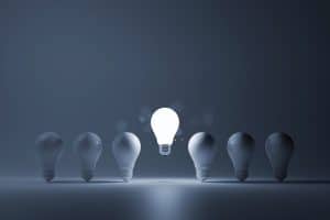 Light bulb bright outstanding among lightbulb on white background. Concept of creative idea and inspire innovation, Think different, Standing out from the crowd. 3d rendering illustration